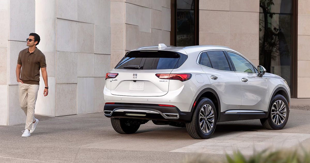 2025 Buick Envision mid-size SUV rear view in white highlighting modern design and technology features