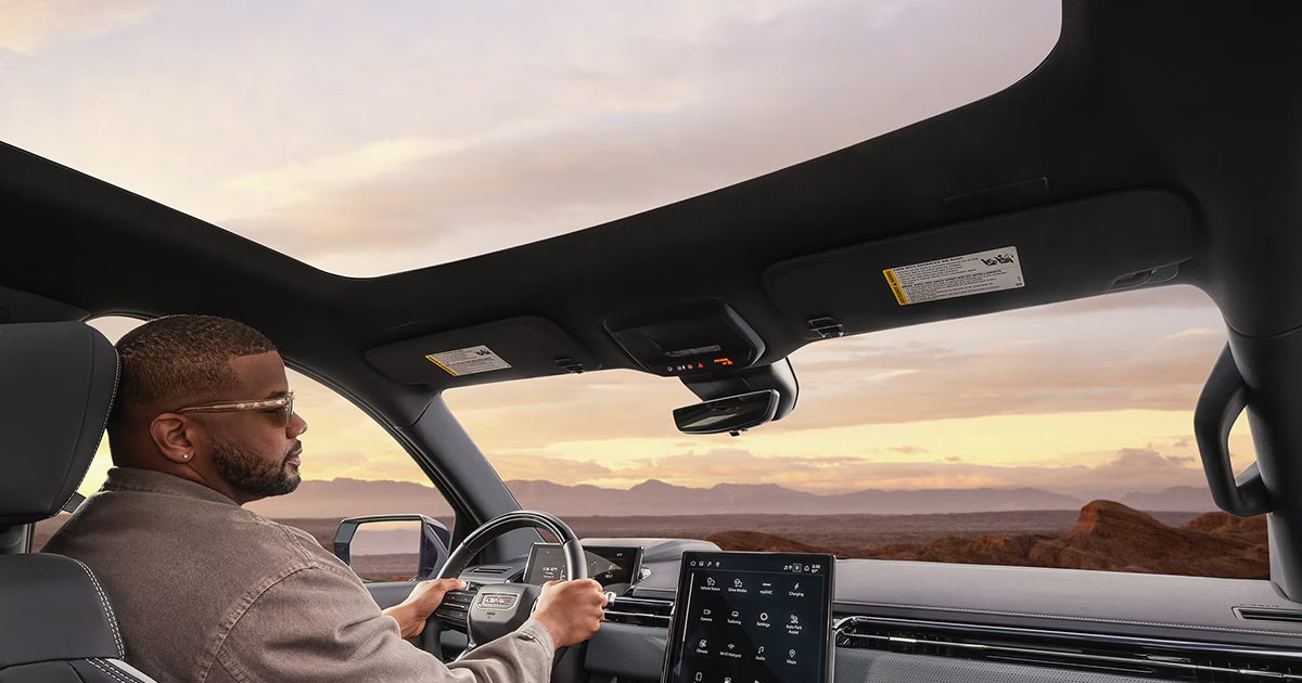 Interior view of GMC Sierra EV electric pickup truck featuring panoramic sunroof and advanced technology dashboard