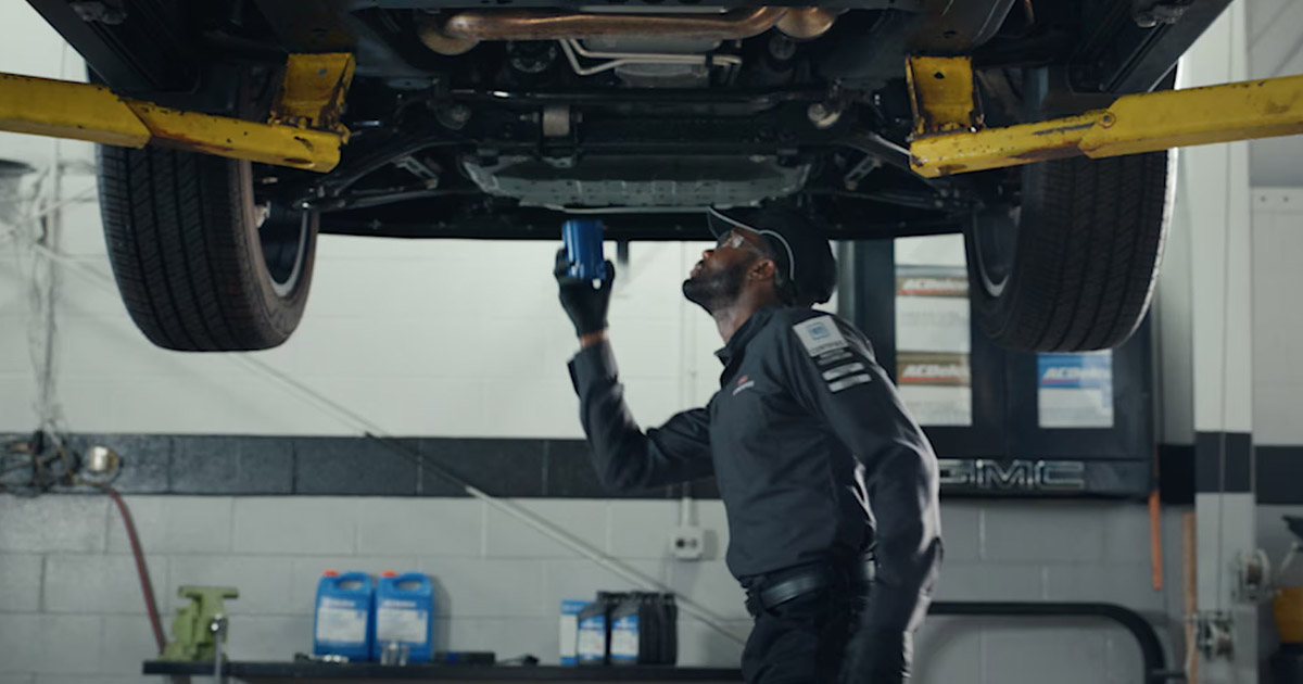 Professional automotive technician performing brake system inspection and maintenance service