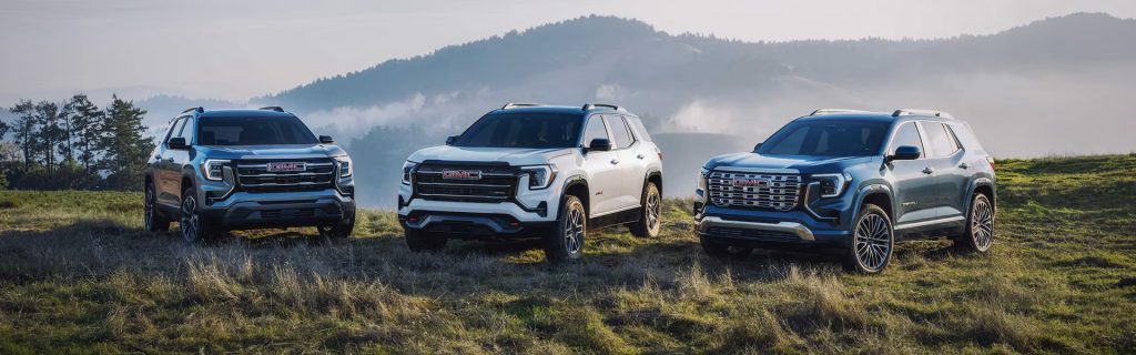 2026 GMC Terrain lineup parked outdoors in a scenic mountain landscape