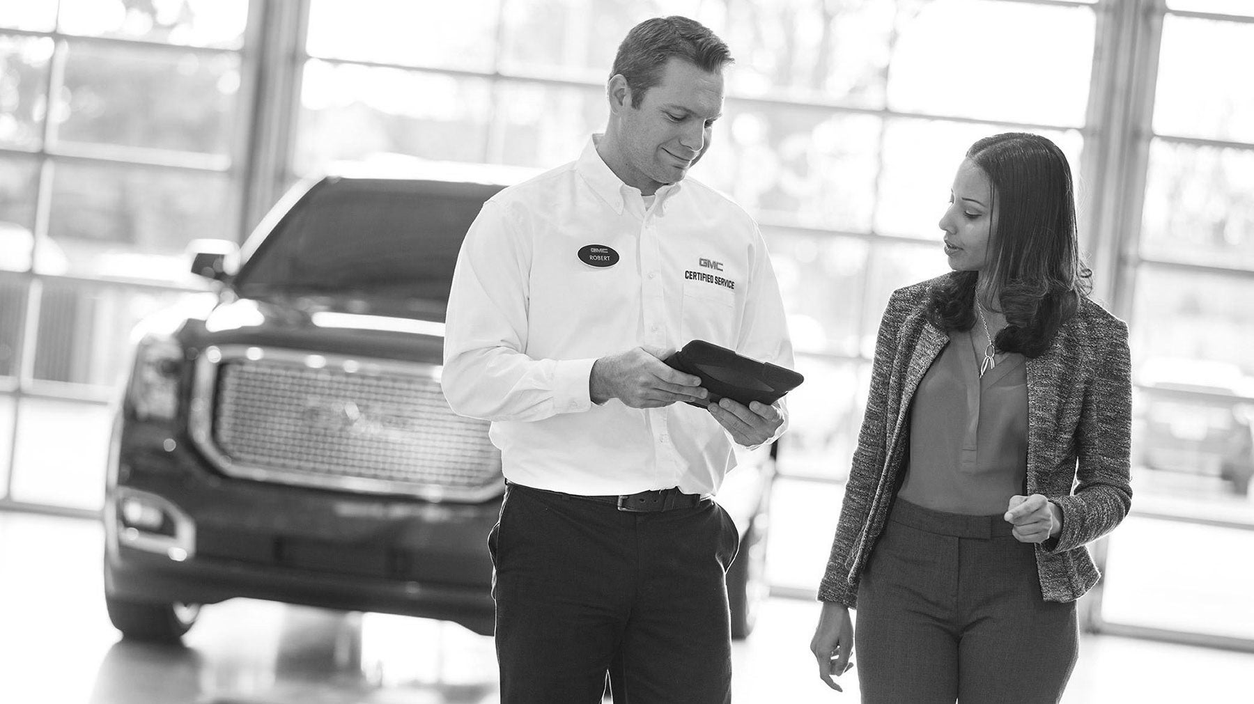 man and woman standing in GMC showroom